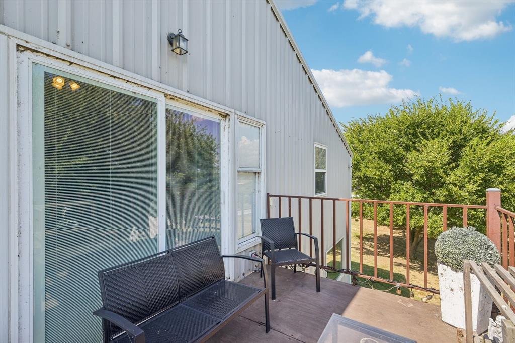 169 Chisam Road Valley View, TX 76272 - Photo 12 of 37 a balcony with with glass top table and chairs