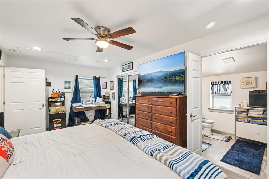 169 Chisam Road Valley View, TX 76272 - Photo 18 of 37 a bedroom with a bed and a dresser in it