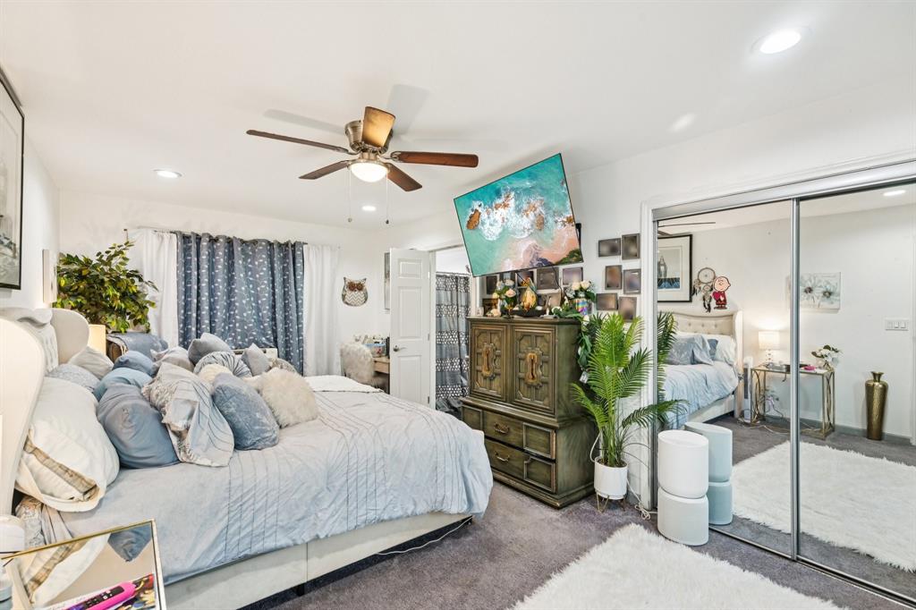 169 Chisam Road Valley View, TX 76272 - Photo 19 of 37 a bedroom with a bed and a chandelier