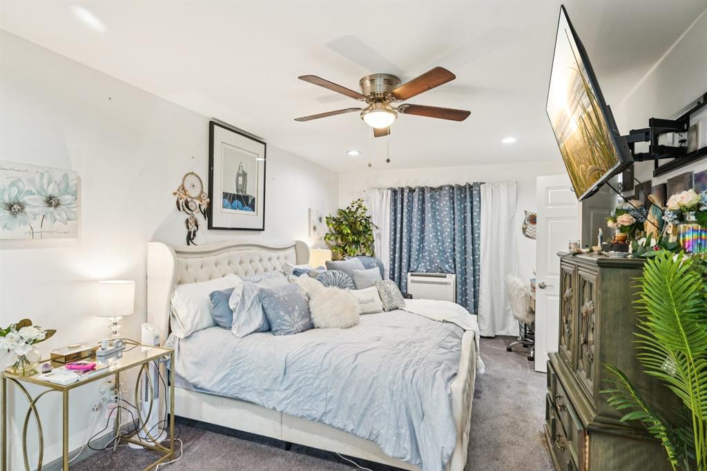 169 Chisam Road Valley View, TX 76272 - Photo 20 of 37 a bedroom with a bed a chandelier and dresser