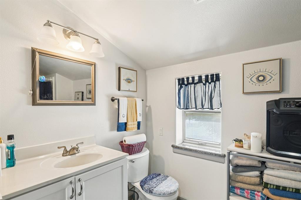169 Chisam Road Valley View, TX 76272 - Photo 22 of 37 a bathroom with a sink toilet and a mirror