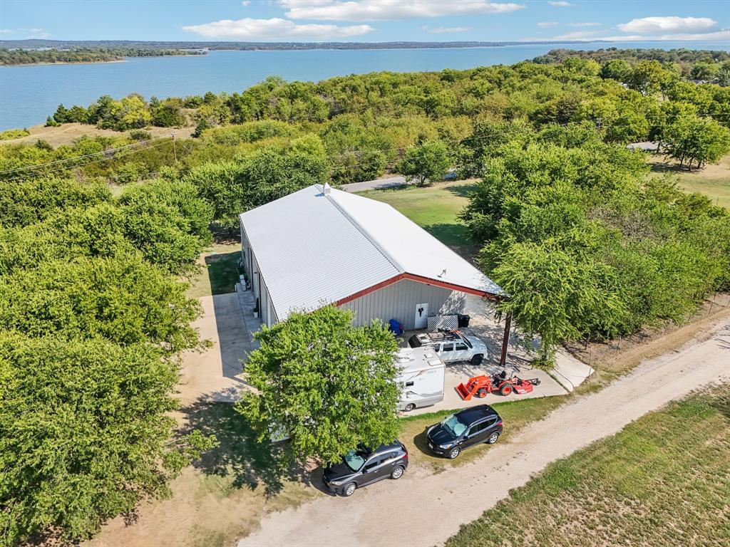 169 Chisam Road Valley View, TX 76272 - Photo 35 of 37 an aerial view of a house with a garden and lake view