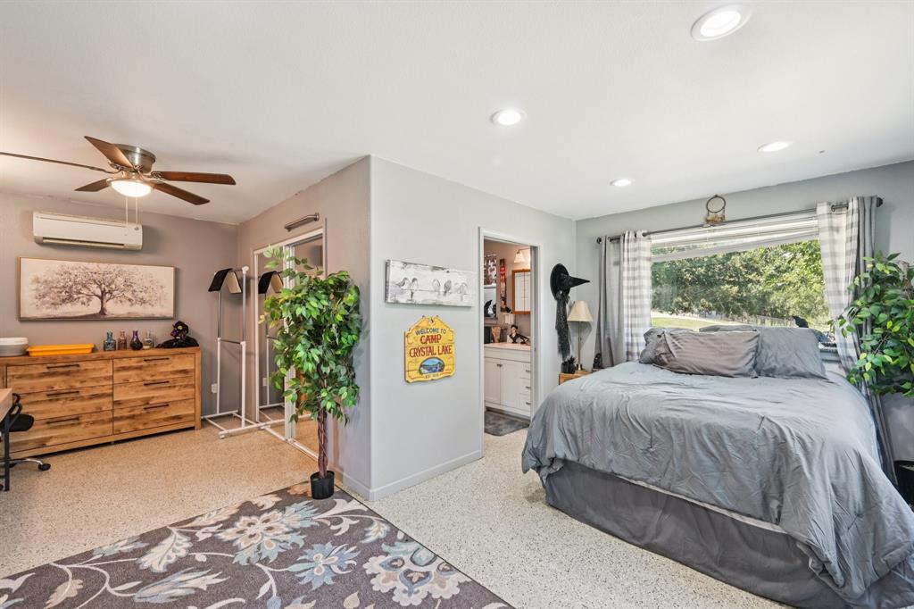 169 Chisam Road Valley View, TX 76272 - Photo 8 of 37 a bedroom with a large bed and a window