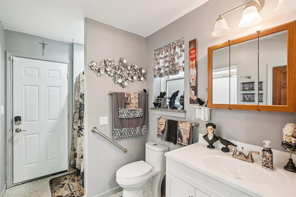 169 Chisam Road Valley View, TX 76272 - Photo 9 of 37 a bathroom with a sink a toilet and shower curtain