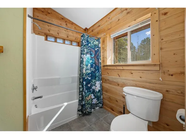 a bathroom with a toilet a sink and bathtub