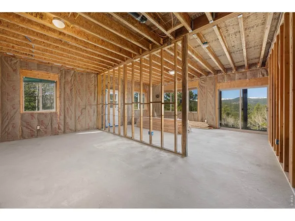 a view of a room with wooden floor