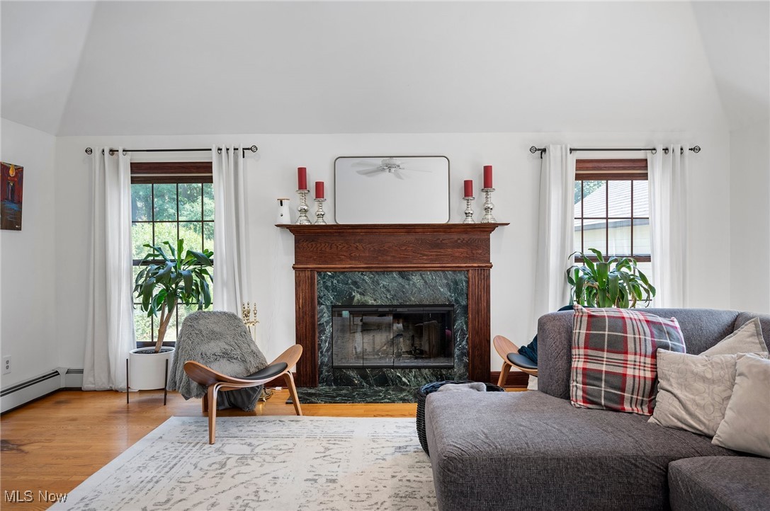 2213 Coventry Road Cleveland, OH 44118 - Photo 16 of 46 Living room featuring hardwood / wood-style flooring, lofted ceiling, a high end fireplace, and a wealth of natural light