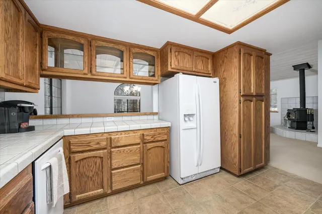 a kitchen with stainless steel appliances granite countertop a refrigerator a stove and a sink