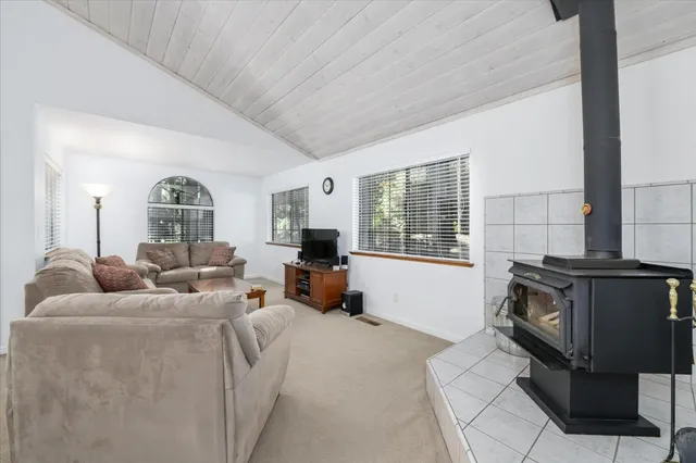 a living room with furniture fireplace and flat screen tv