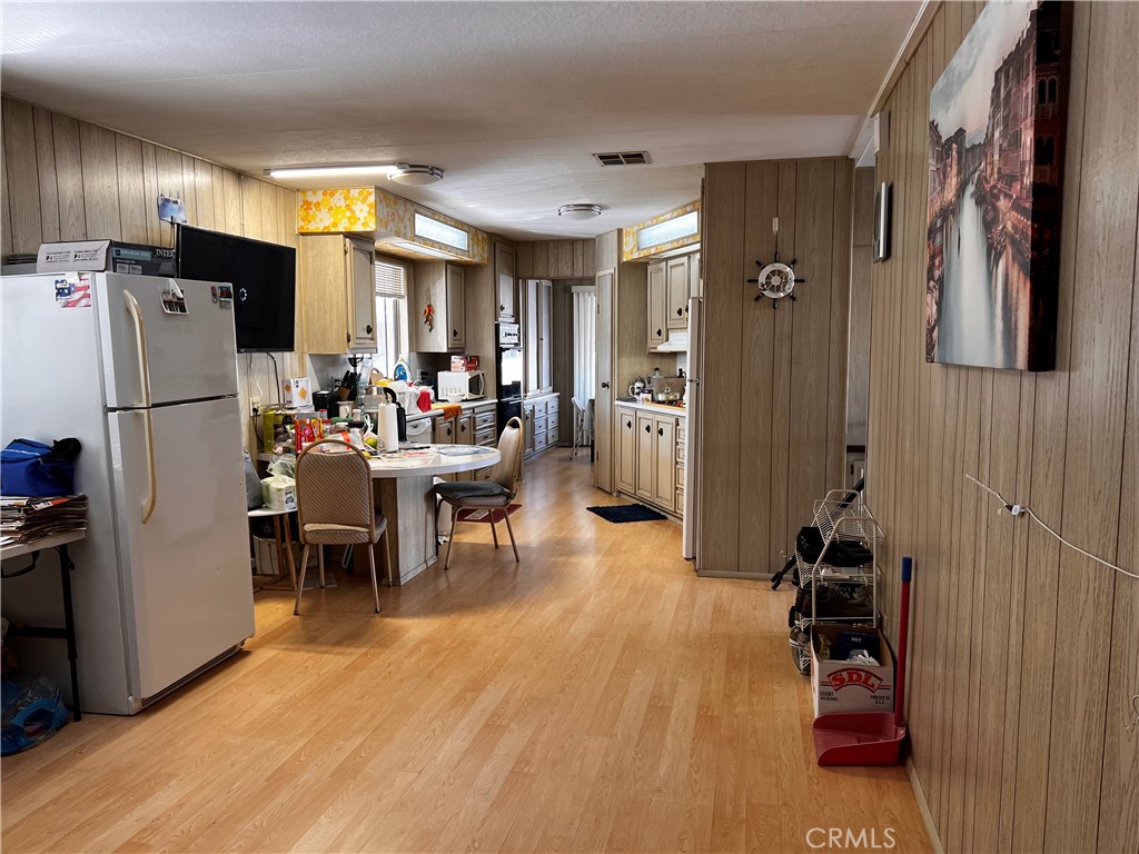 12101 Dale Avenue, Unit 69 Stanton, CA 90680 - Photo 3 of 5 a kitchen with a refrigerator and a dining table