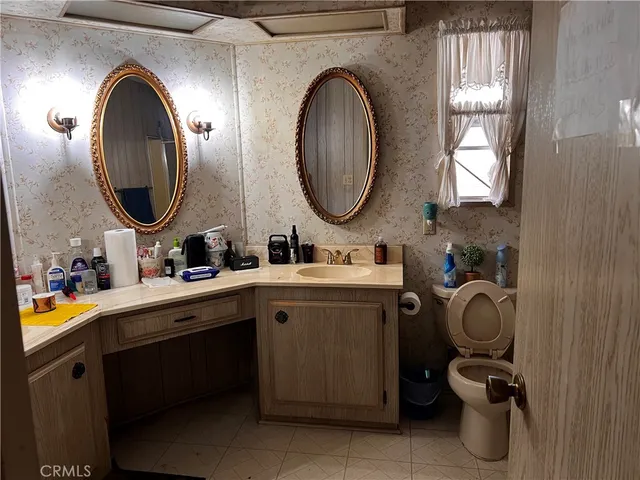a bathroom with a toilet sink and mirror