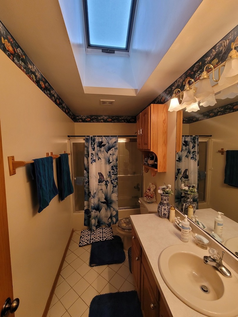 3246 East Forestview Trail Crete, IL 60417 - Photo 5 of 12 a bathroom with a sink and a mirror