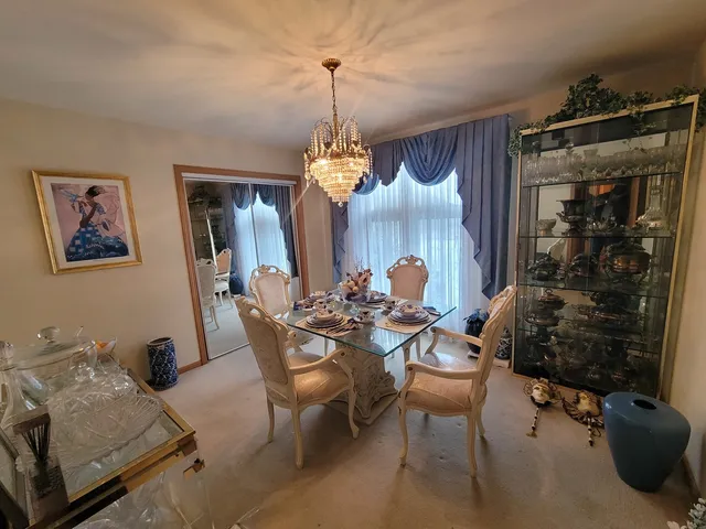 a view of a dining room with furniture and chandelier