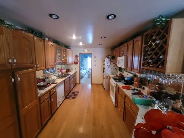 a kitchen with stainless steel appliances kitchen island granite countertop a stove and a refrigerator