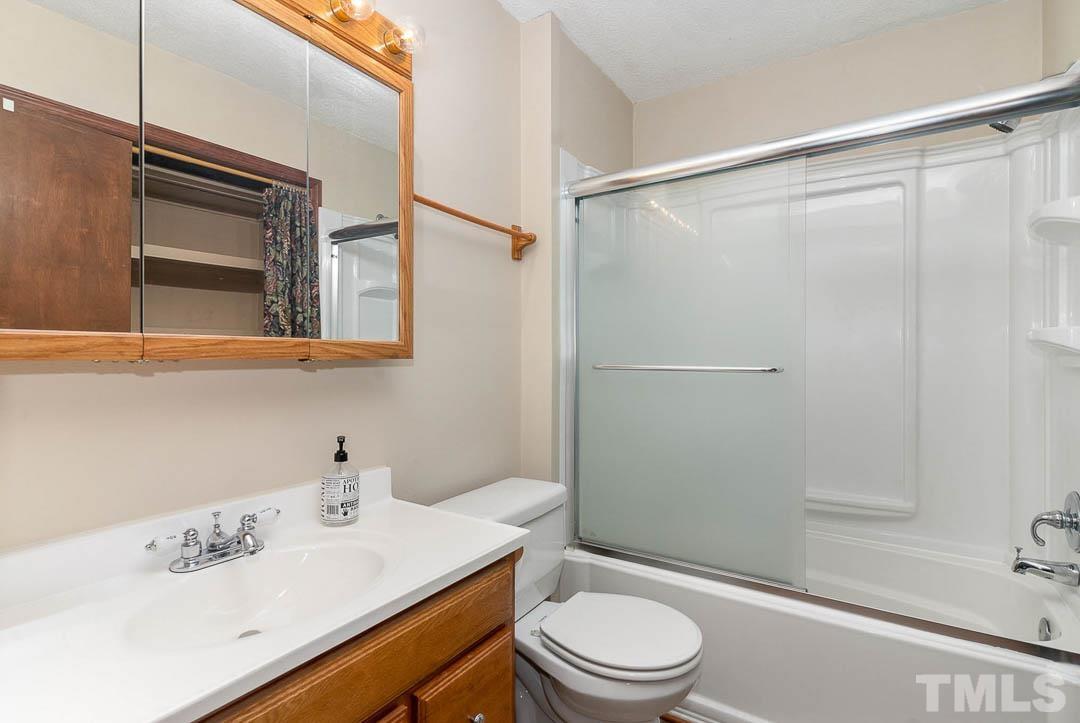 7244 Mine Shaft Road Raleigh, NC 27615 - Photo 11 of 23 a bathroom with a sink a toilet and shower