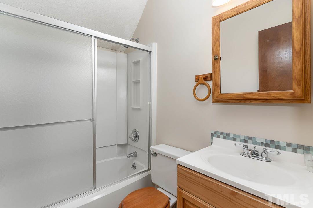 7244 Mine Shaft Road Raleigh, NC 27615 - Photo 15 of 23 a bathroom with a sink toilet and shower
