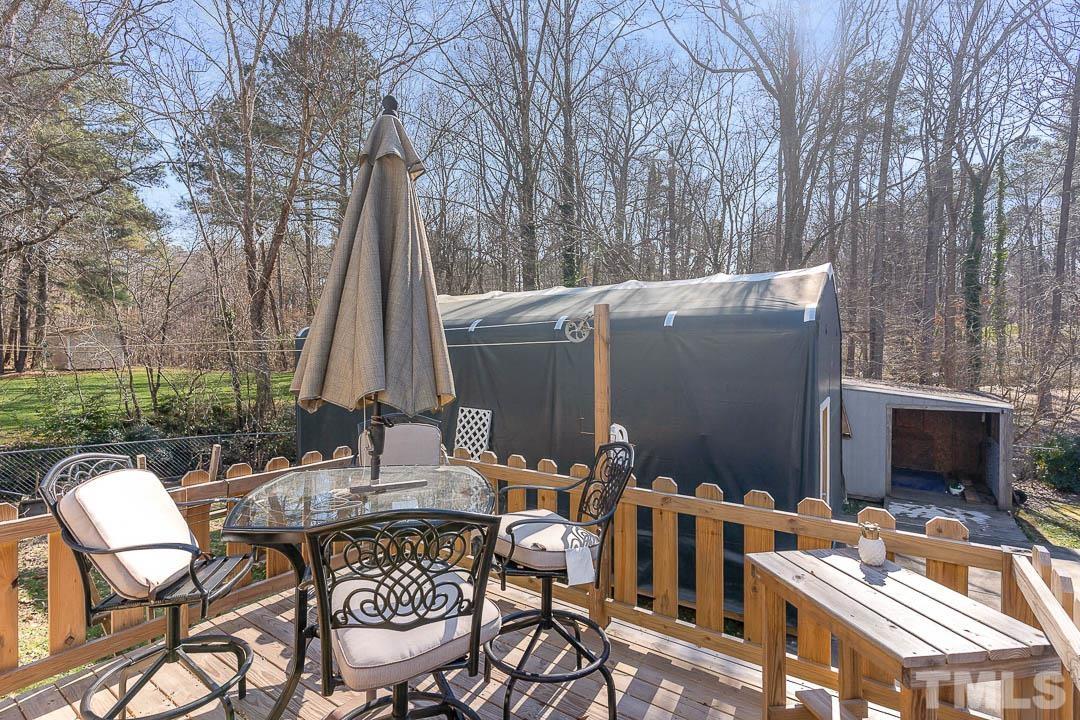 7244 Mine Shaft Road Raleigh, NC 27615 - Photo 23 of 23 a view of a dinning table and chairs in the patio