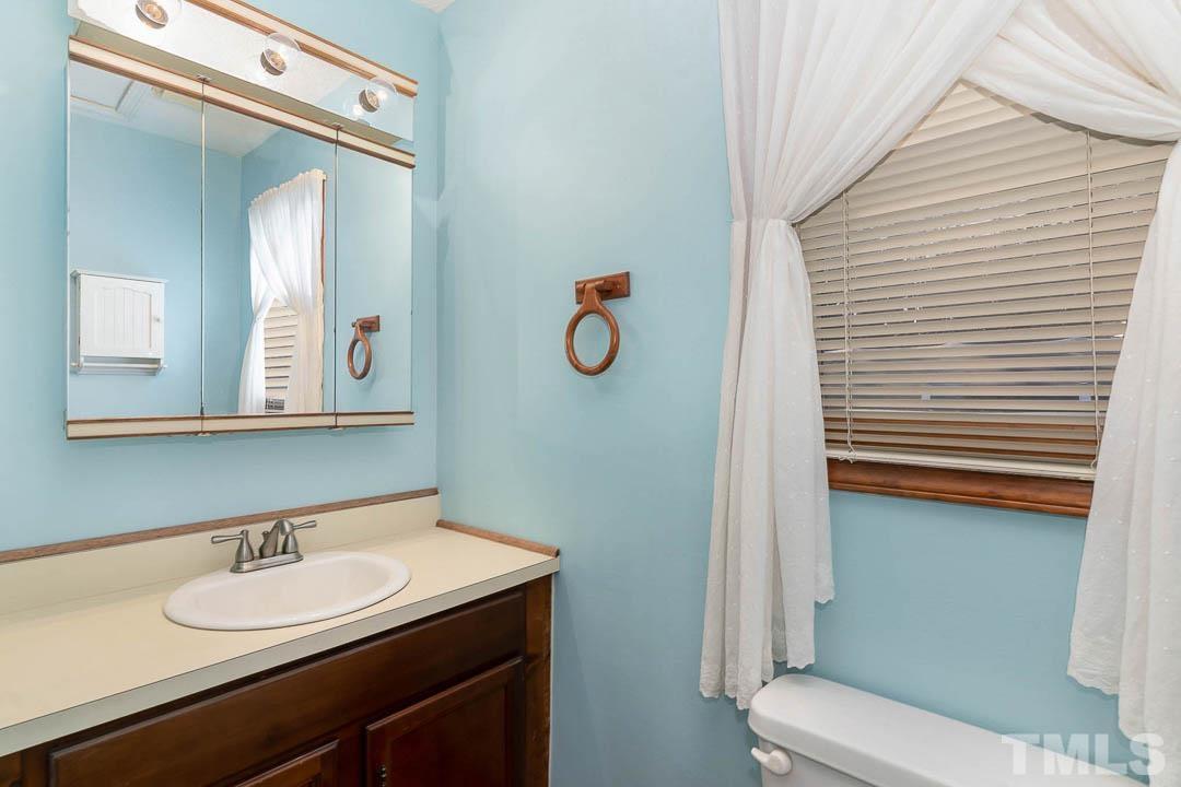 7244 Mine Shaft Road Raleigh, NC 27615 - Photo 5 of 23 a bathroom with a sink and a mirror