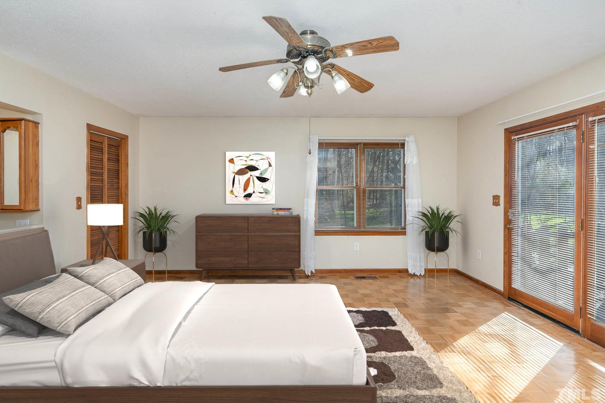 7244 Mine Shaft Road Raleigh, NC 27615 - Photo 6 of 23 a bedroom with a large bed and a chandelier