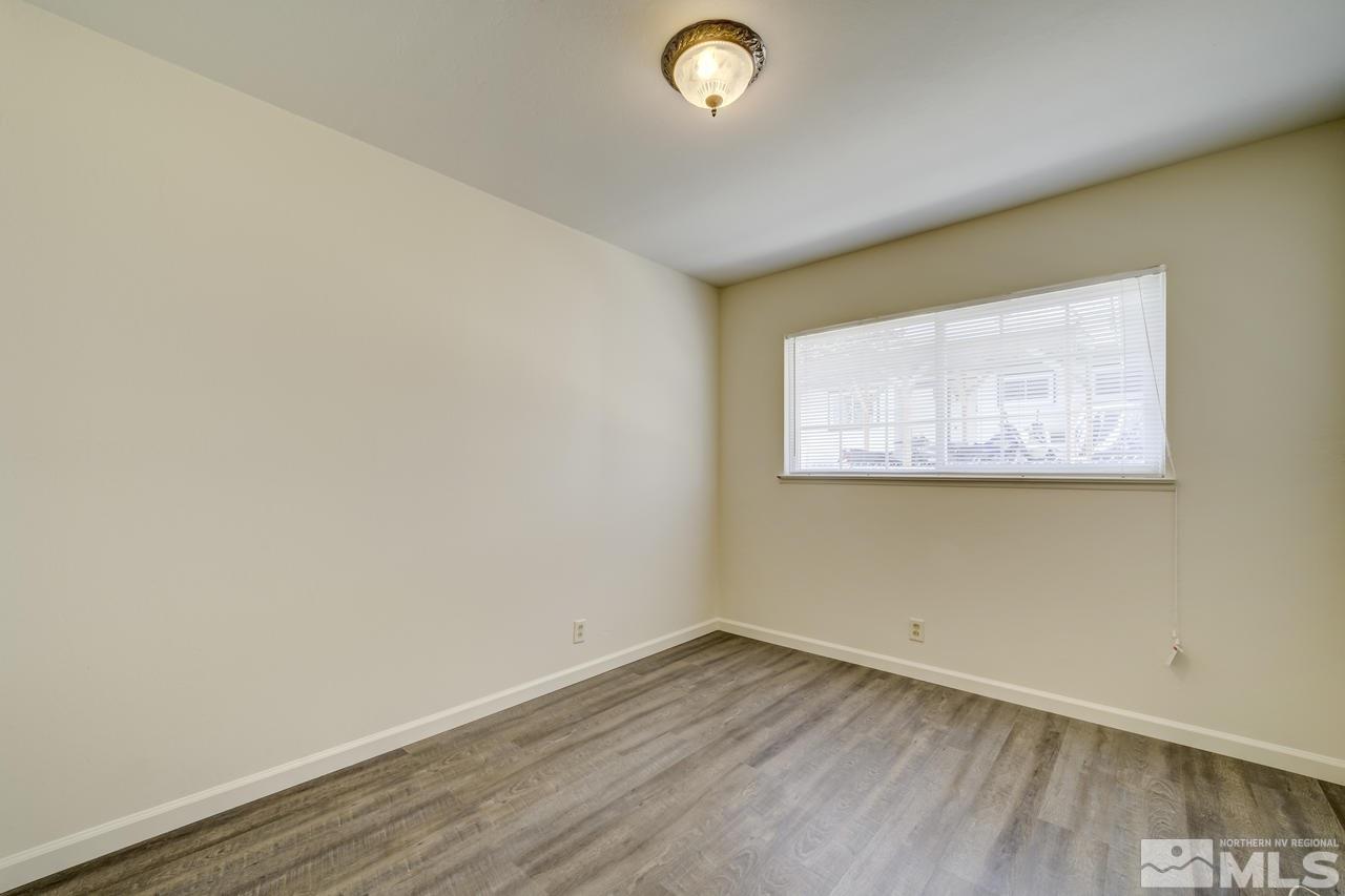 2001 Arcane Avenue Reno, NV 89503 - Photo 12 of 25 an empty room with wooden floor and windows