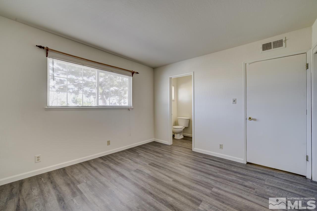 2001 Arcane Avenue Reno, NV 89503 - Photo 16 of 25 a view of an empty room with wooden floor and a window