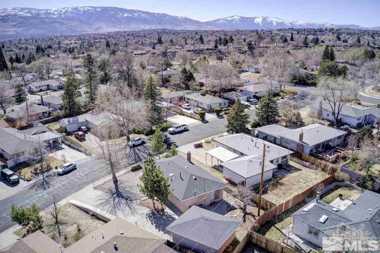 2001 Arcane Avenue Reno, NV 89503 - Photo 24 of 25 an aerial view of a city with lots of residential buildings and mountain view in back