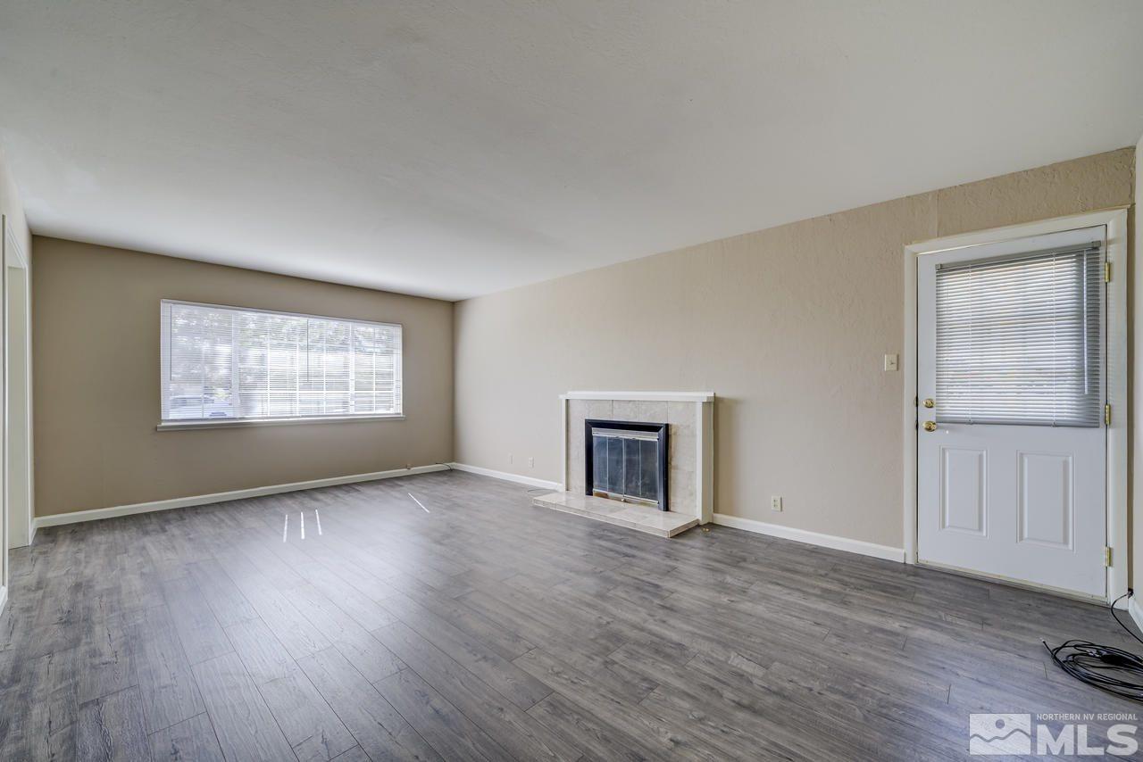2001 Arcane Avenue Reno, NV 89503 - Photo 4 of 25 a view of an empty room with a window and wooden floor