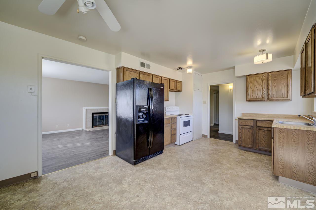 2001 Arcane Avenue Reno, NV 89503 - Photo 9 of 25 a kitchen with stainless steel appliances kitchen island granite countertop a refrigerator and a sink