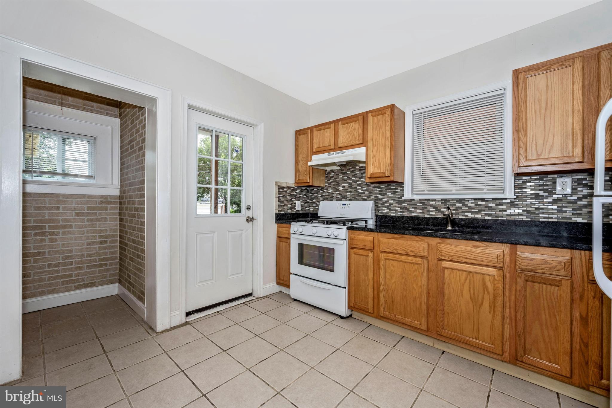 7041 Dunbar Road Dundalk, MD 21222 - Photo 12 of 28 Kitchen with rear yard acces and pantry/storage