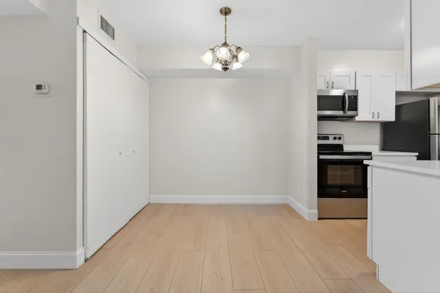 a kitchen with a sink cabinets and window
