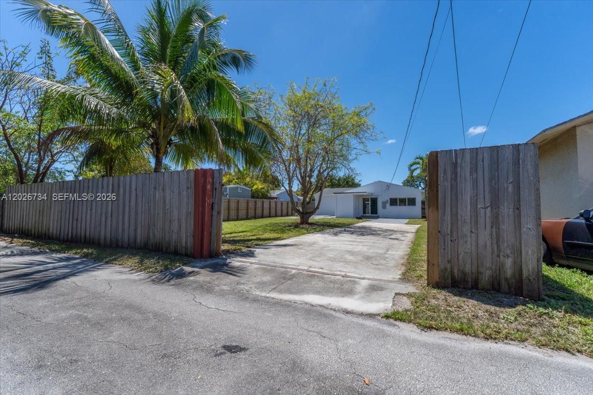 266 Southwest 6th Street Dania Beach, FL 33004 - Photo 34 of 37 a view of a backyard with potted plants and wooden fence