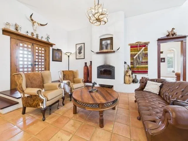a living room with fireplace furniture and a table