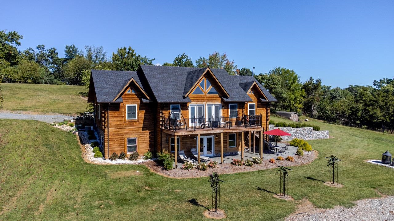 a aerial view of a house with swimming pool garden view and lake view