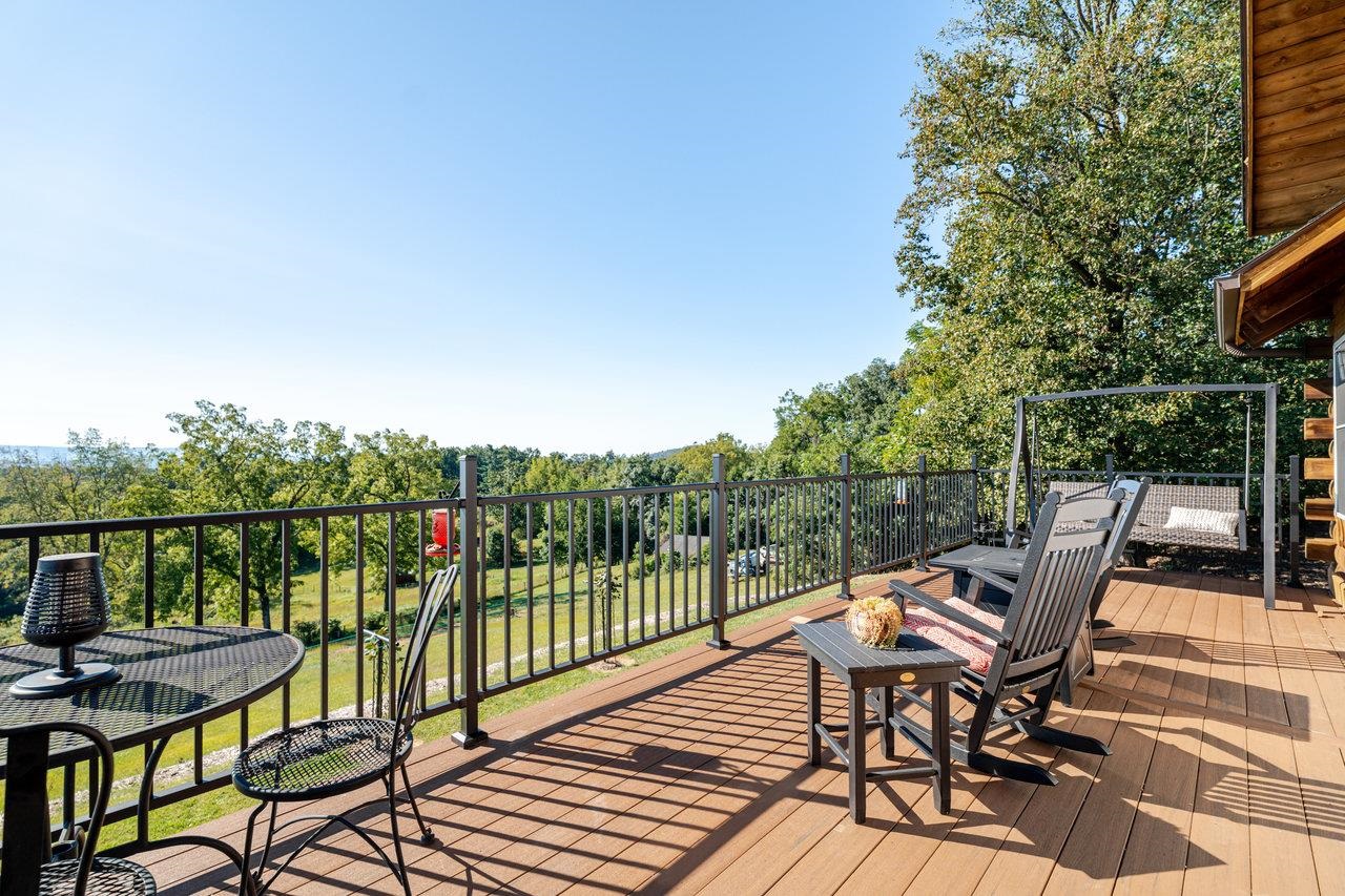 12012 Hollar School Road Linville, VA 22834 - Photo 16 of 75 a view of a balcony with wooden floor and outdoor seating