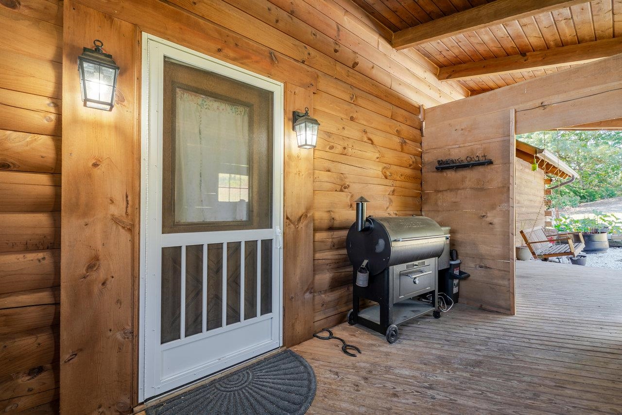 12012 Hollar School Road Linville, VA 22834 - Photo 8 of 75 a view of a balcony with chair and front door