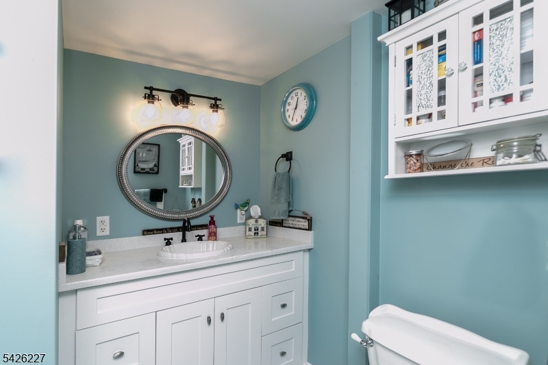 36 Main Street Flanders, NJ 07836 - Photo 28 of 49 a bathroom with a toilet a sink and a mirror