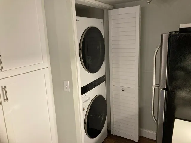 a bathroom with a granite countertop toilet and a bathtub