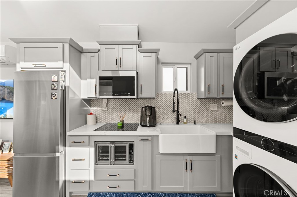 8601 Links Road Buena Park, CA 90621 - Photo 47 of 75 Kitchen with Built-In Oven, Farmhouse Sink, and Washer/Dryer