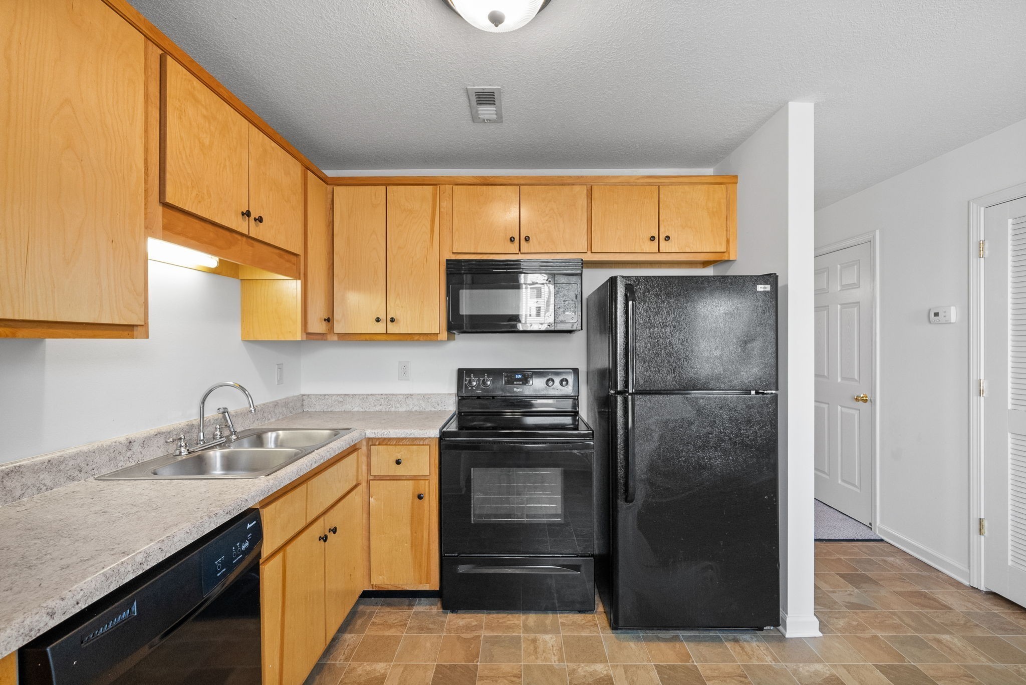 512 Peachers Ridge Road, Unit 3A Clarksville, TN 37042 - Photo 7 of 15 a kitchen with a refrigerator sink and cabinets