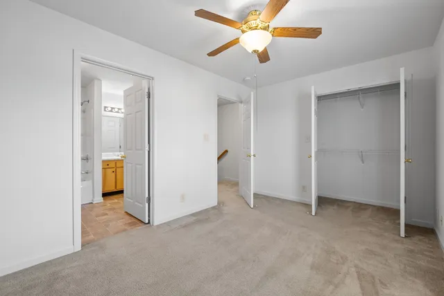 an empty room and chandelier fan