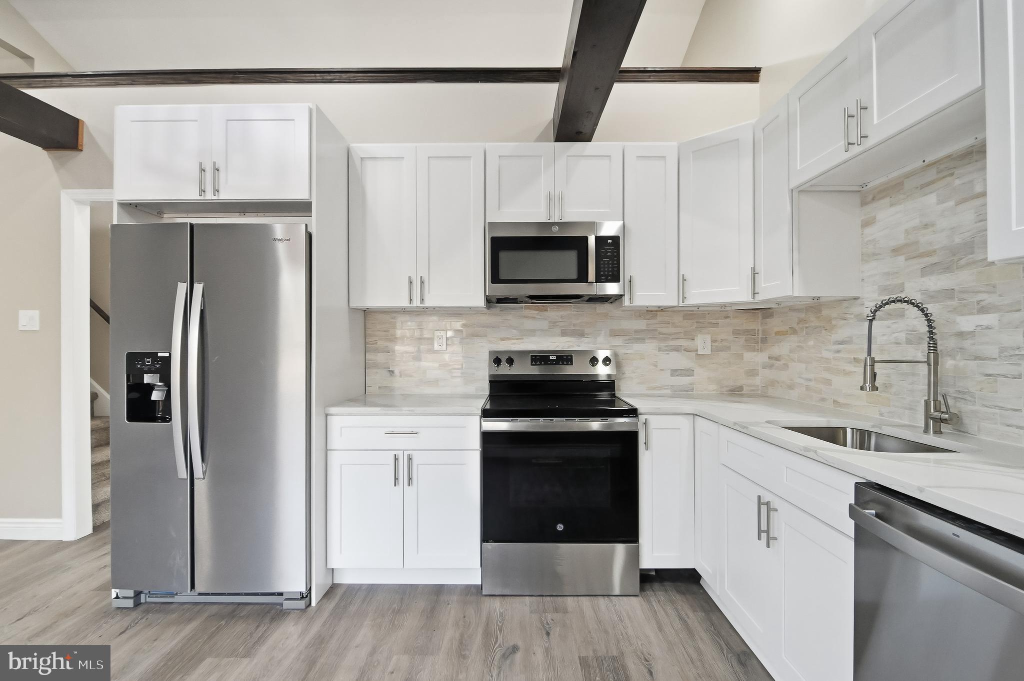 62 Grassy Lake Road Shamong, NJ 08088 - Photo 2 of 25 a kitchen with stainless steel appliances a refrigerator sink and microwave