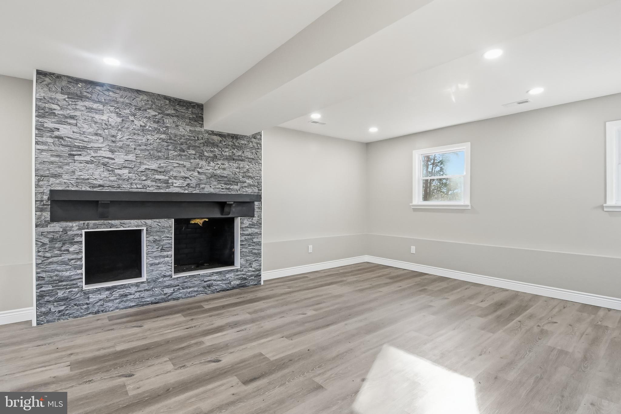 62 Grassy Lake Road Shamong, NJ 08088 - Photo 8 of 25 a view of empty room with wooden floor and fireplace
