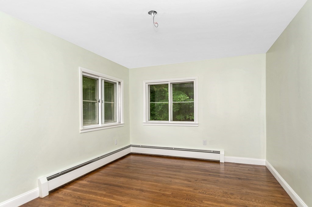 49 Parham Road Tyngsborough, MA 01879 - Photo 16 of 31 an empty room with wooden floor and windows