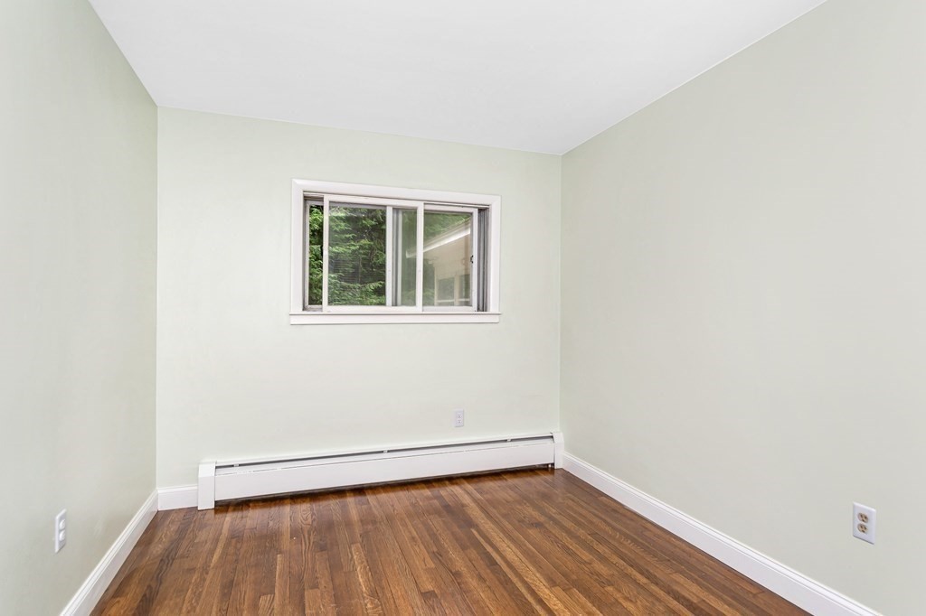 49 Parham Road Tyngsborough, MA 01879 - Photo 18 of 31 an empty room with wooden floor and windows