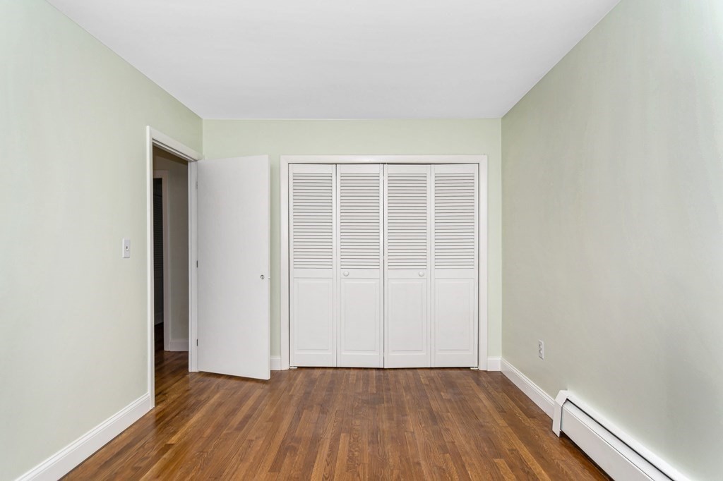 49 Parham Road Tyngsborough, MA 01879 - Photo 21 of 31 an empty room with wooden floor and windows
