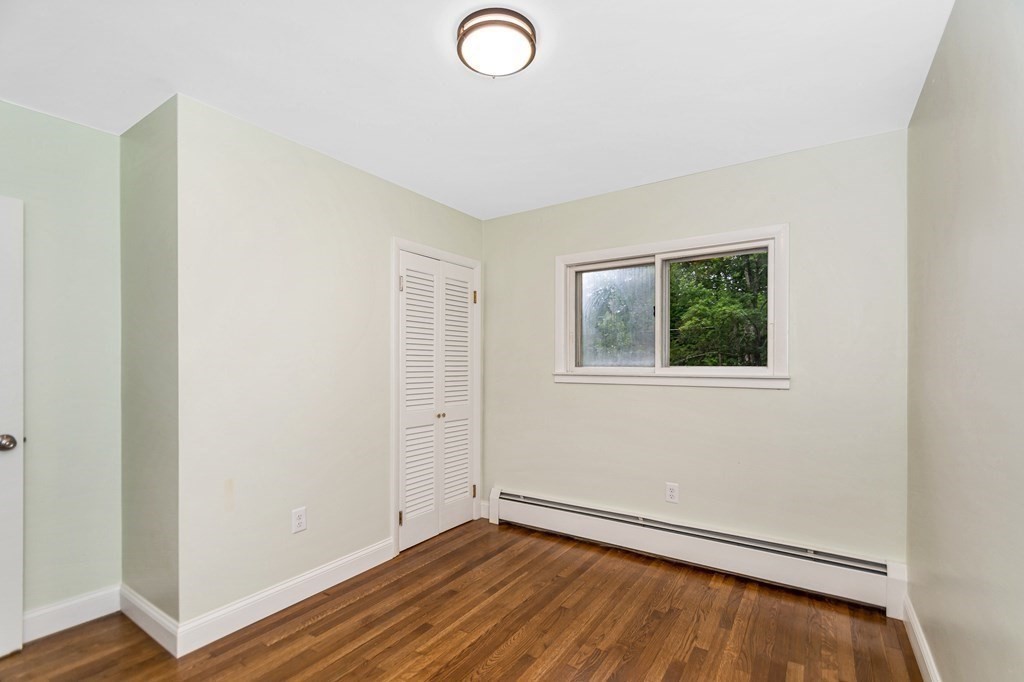 49 Parham Road Tyngsborough, MA 01879 - Photo 22 of 31 an empty room with wooden floor and windows