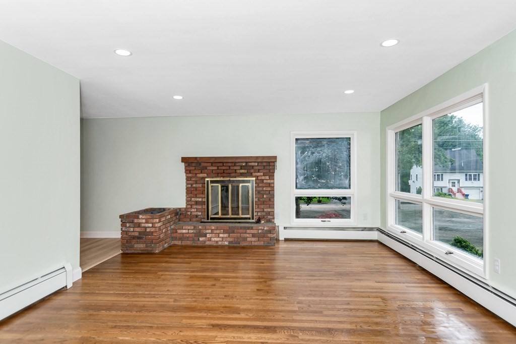 49 Parham Road Tyngsborough, MA 01879 - Photo 5 of 31 a living room with fireplace furniture and a large window