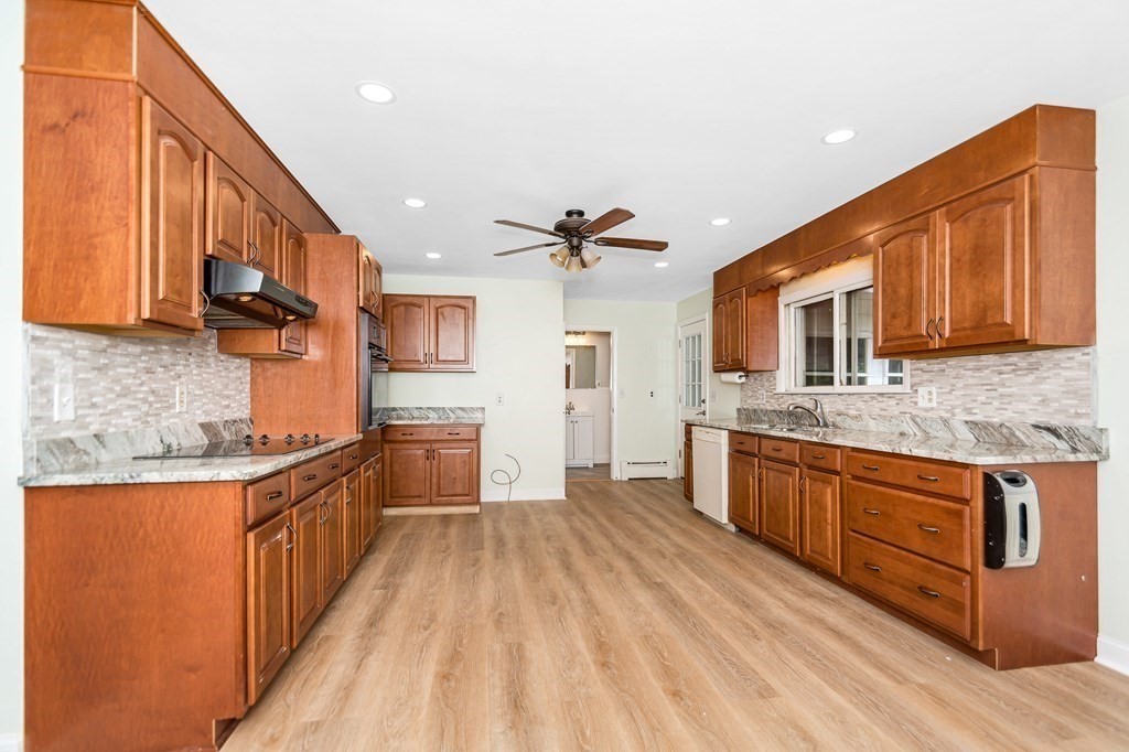 49 Parham Road Tyngsborough, MA 01879 - Photo 7 of 31 a kitchen with stainless steel appliances granite countertop wooden cabinets a stove top oven a sink and dishwasher