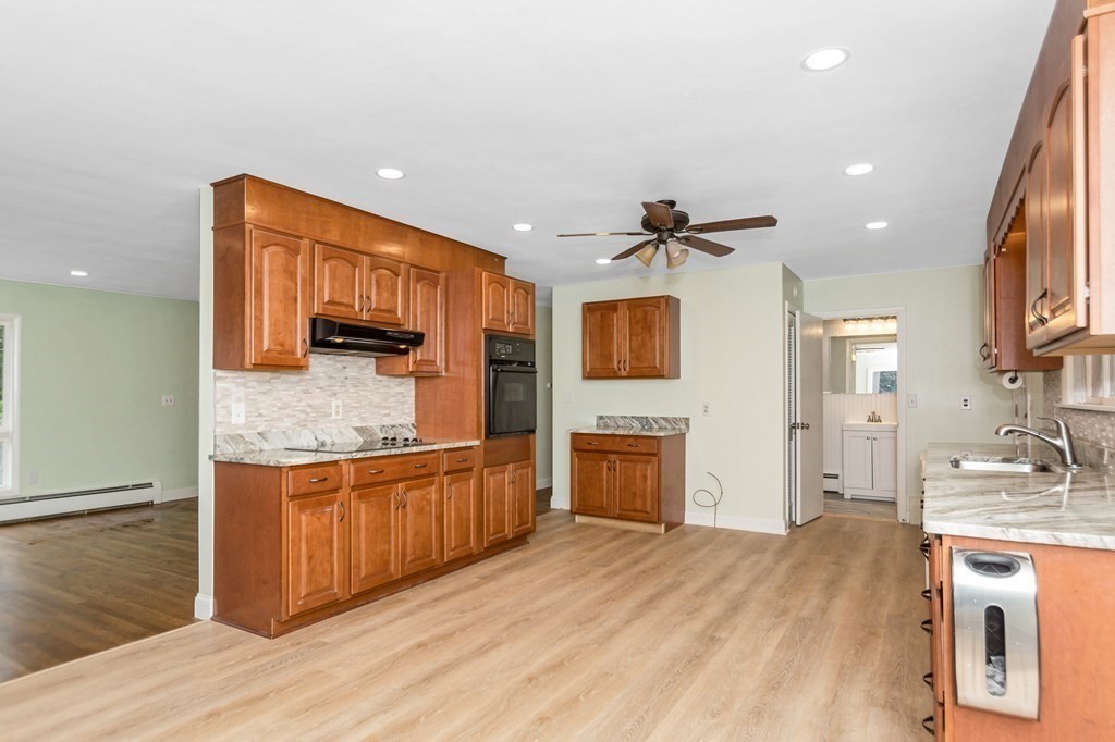 49 Parham Road Tyngsborough, MA 01879 - Photo 9 of 31 a kitchen with stainless steel appliances granite countertop a sink stove and refrigerator