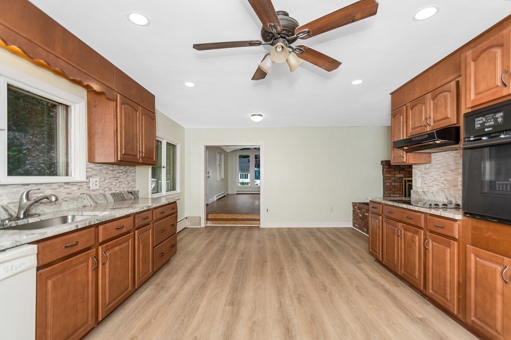 49 Parham Road Tyngsborough, MA 01879 - Photo 10 of 31 a large kitchen with stainless steel appliances granite countertop a sink dishwasher stove and wooden cabinets
